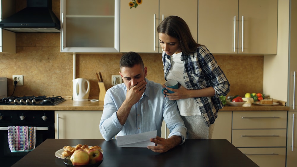 A couple reviewing a bill together at their kitchen table